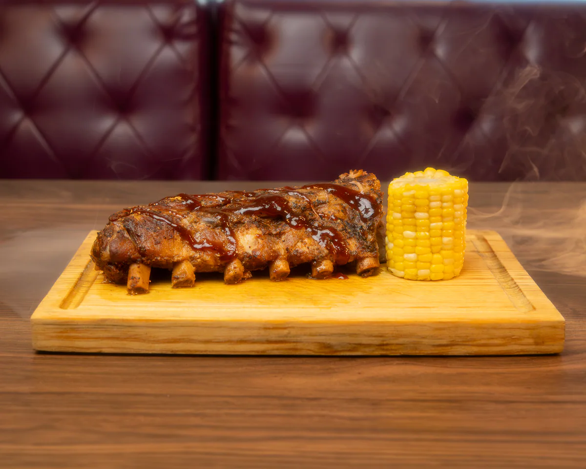 Orden de seis baby back ribs BBQ con tiras de elote en Cancún